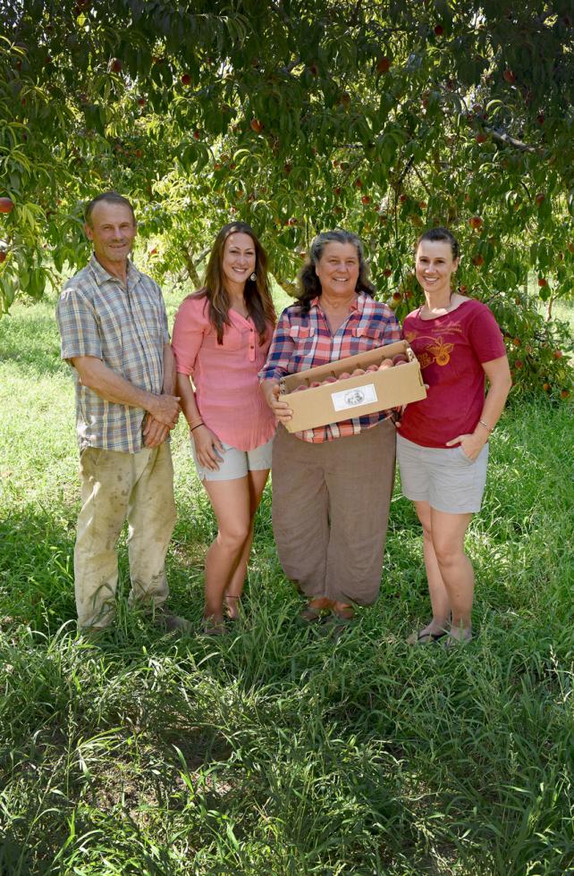 From left: Jeff, Claire, Annie and Alison Main in their peach orchard at Good Humus Produce in Capay Valley.