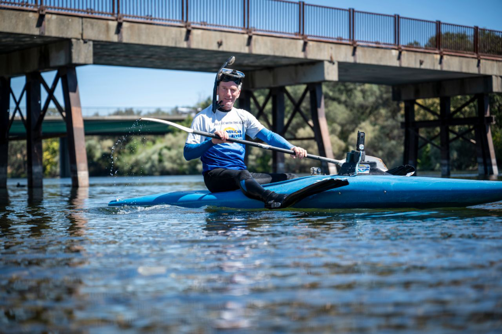 Karl Bly has been treasure hunting on the American River for over 50 years. His strategy involves paddling with his face in the water to scan for any glint of foreign material that may indicate a find. (Photo by Gabriel Teague)