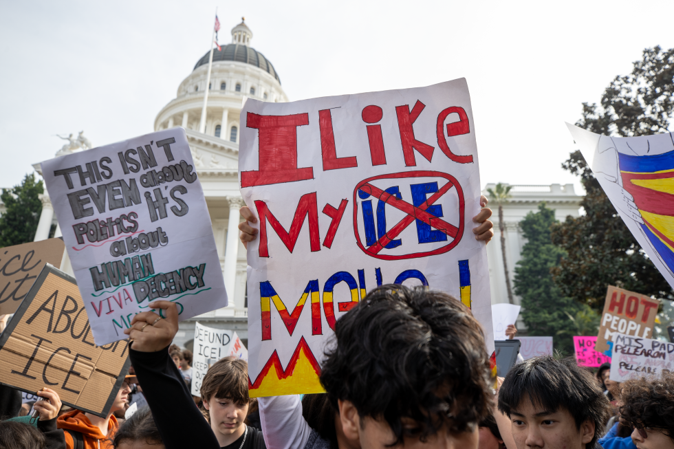 The state Capitol stands in the background as student protesters gather.