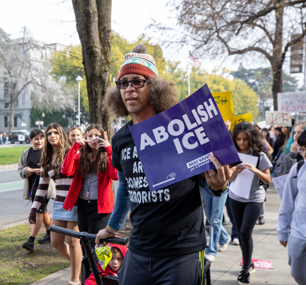 A protester pulls his child in a wagon.