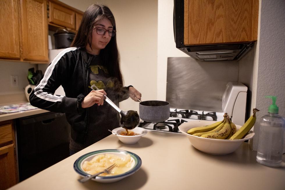 Beverly Callupe, 20, prepares lunch in a homeless shelter after an English class at Sacramento City College. Some days, she skipped lunch to save money. She recently dropped all her classes so she could focus on finding work. (Photo by Anne Wernikoff for CalMatters)