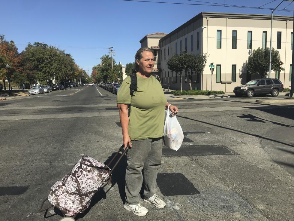 Sharon Johnston-Corson, 50, leaves the River City Food Bank in Sacramento, where she reapplied for CalFresh and picked up food for herself, her husband and her teenage twins. (Photo by Jackie Botts for CalMatters)