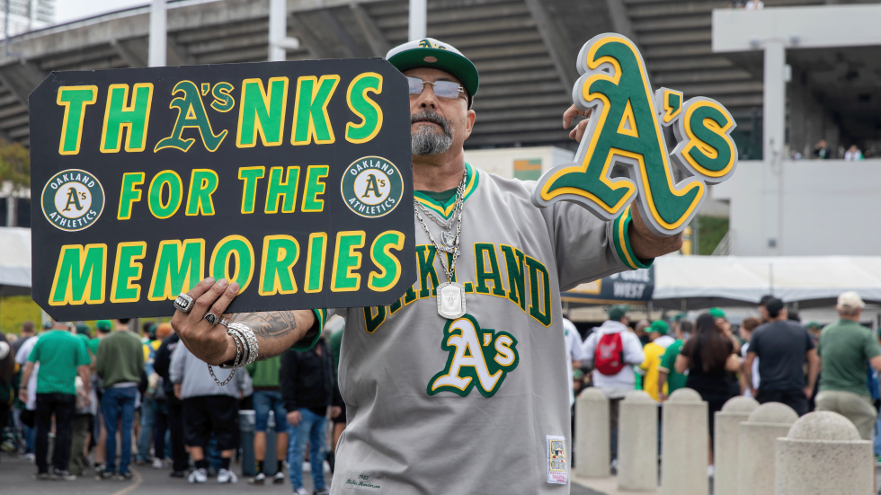 A’s fan Andrew Rodriguez with signage outside the Oakland Coliseum before the last game there on Sept. 26.