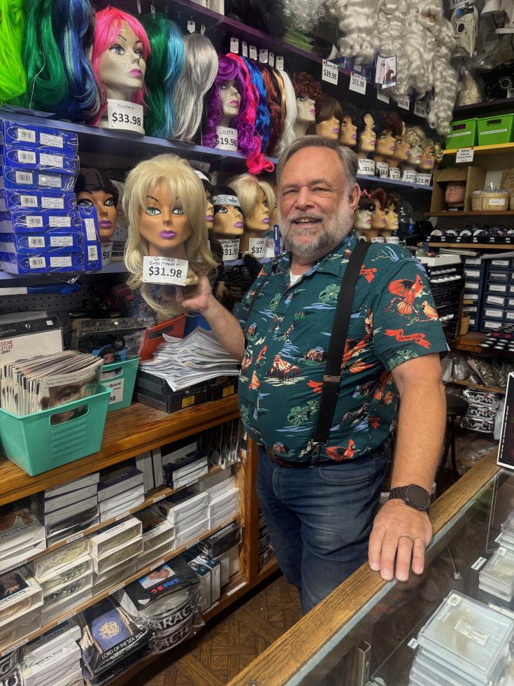 Broadway Costumes’ Larry Dockter displays a “Country Sweetheart” blonde wig at his shop on Wednesday, Sept. 16. (Photo by Helen Harlan)