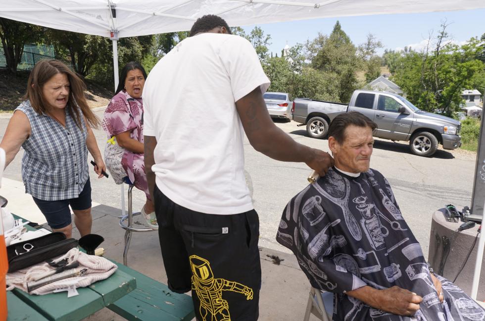 Attendees receive free haircuts from 360 Degree Barber Shop in Roseville and retired hairstylist Sandy Lynn.