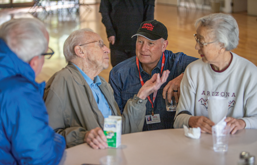 Pictured: Kirk Utzinger visiting participants of the All Seasons Cafe at Mission Oaks