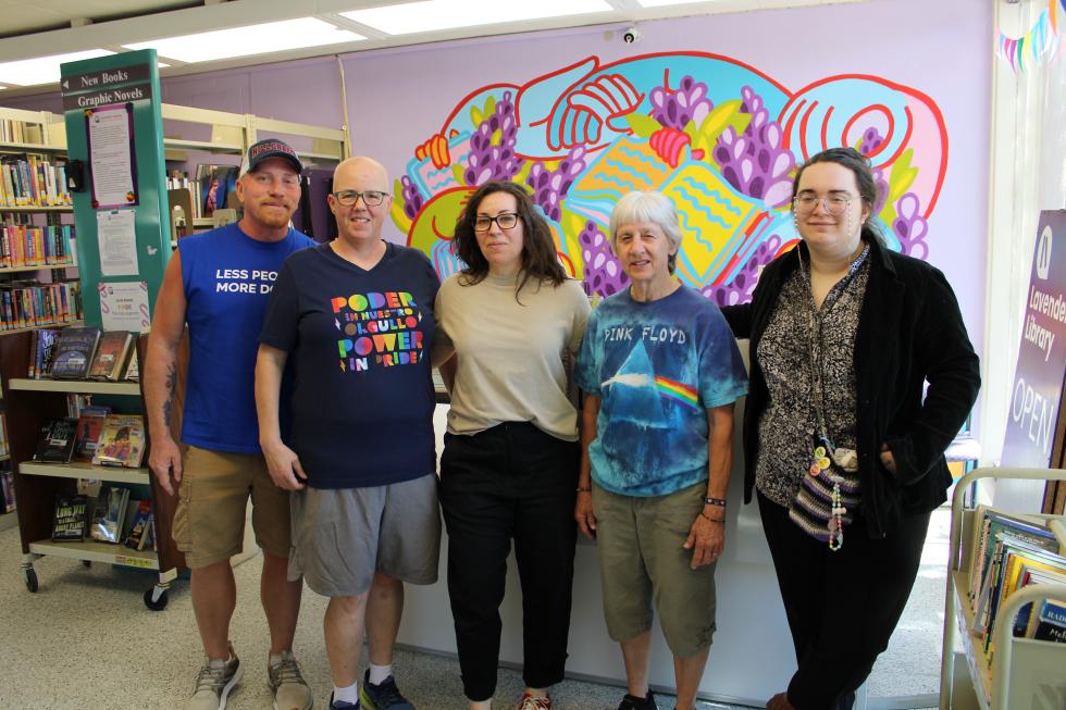 Clint Vigen, Kerry Parsons, Michelle Trujillo, Nancy McKernan and Rayna Sheftman stand at the opening counter at the Lavender Library on 1414 21st Street. (Photo by Jacob Peterson)