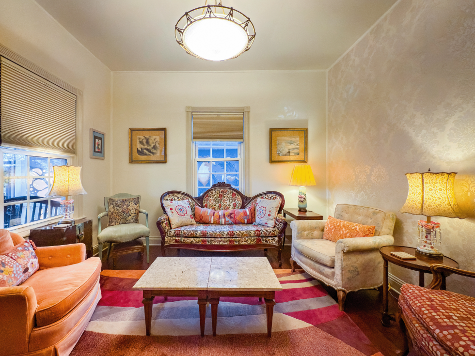 Period-correct Victorian furniture graces the living room that once served as a bedroom when two families lived in the home in the early 20th century.