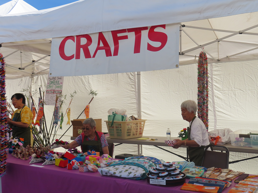Donated home goods, clothing, artwork, and household goods items fill the festival’s thrift stall, with proceeds supporting the Placer County Buddhist Church. (Photo by Adiva Mittal)