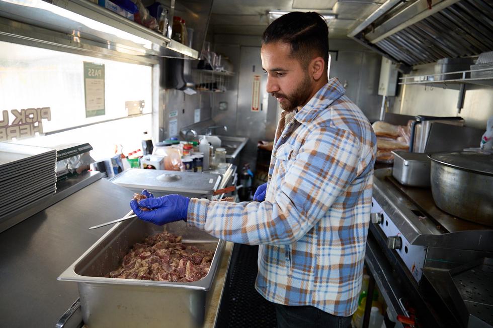 Zaki Rahain works in the food truck associated with his Carmichael restaurant, Lapis Grill.