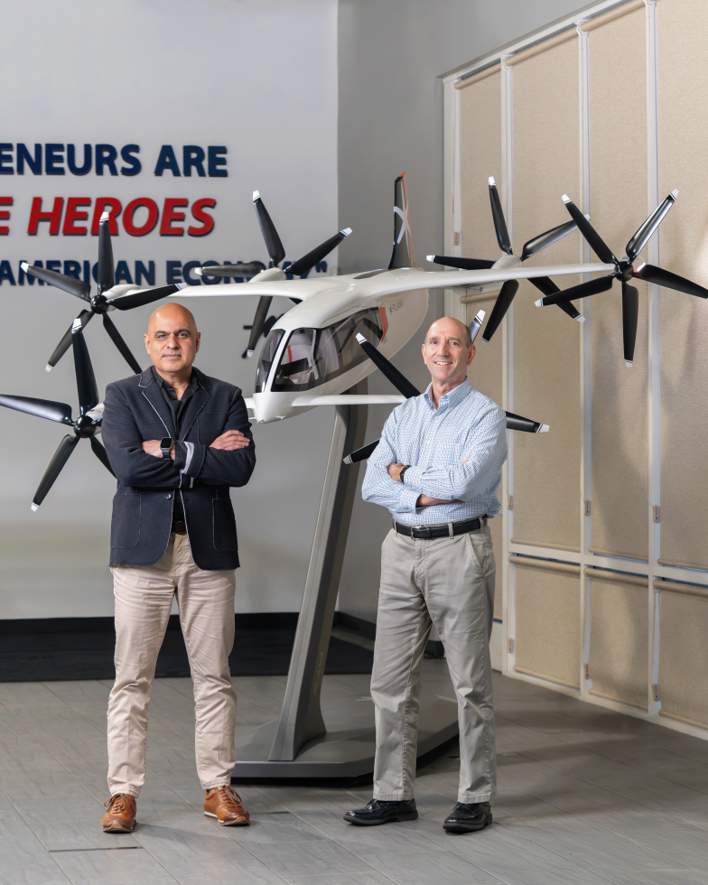 Ali Mackani, left, and Rick Spencer pose with a PLANA model plane. (Photo by Kial James)