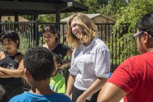 Intern Camryn Agnello leads an ice-breaker game with children attending summer camp at Sacramento Food Bank & Family Services
