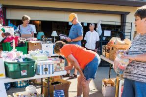 Visitors and shoppers mill about the annual Active 20-30 of Greater Sacramento No. 1032’s fundraiser garage sale, held this year in East Sacramento.