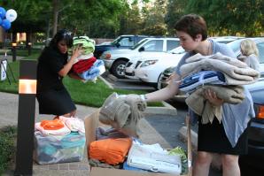 Women in Philanthropy members sort through towels donated for local emancipating foster youth.

