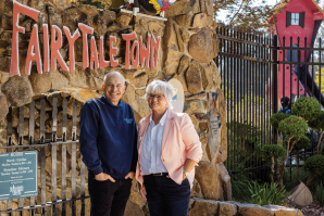 Director Kevin Smith-Fagan and Francie Dillon, a Sac State arts educator who wrote stories and songs for the whimsical storybook playsets, stand outside the entrance to Fairytale Town. (Photos by Wes Davis)