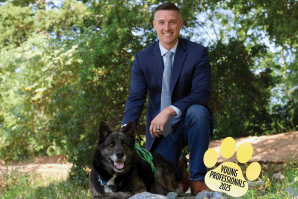 Chris Cormier is CEO, president and co-owner of Tricorp Group. The handsome canine is Khan, a German shepherd mix. (Photo by Fred Greaves, expanded with Adobe)
