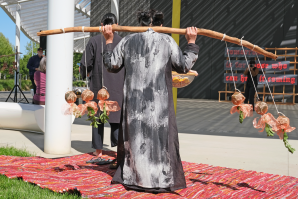 At the start of the performance, Phan took up a yoke and, to the rhythm of “Sài Gòn,” half-danced to the first installation, “Spring 1975: Volcano Altar,” on which is projected a video montage of refugees. (Photos by Anna Dobrowolski)