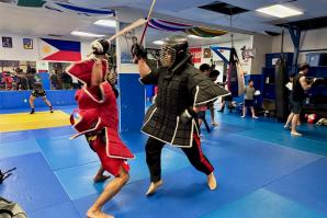 Sacramento eskrimadors Jeremy Mayberry-Antolin, left, and Charley Malagum spar inside the Rancho Cordova Martial Arts Center. (Photo by Scott Thomas Anderson)