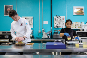 Associate chef Jared Goldstein crafts avocado
toast with mycoprotein bacon and sausage while
food technician Danica Tan works on product
formulations in the test kitchen at Better Meat Co.
in West Sacramento.