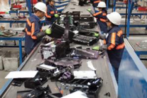 Workers process e-waste at Sims Recycling Solutions in Roseville