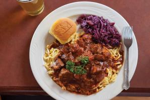 Hungarian pork sirloin goulash stewed with onion, garlic, paprika, caraway and red cabbage, served with spatzle and a pint of Warsteiner Pilsner