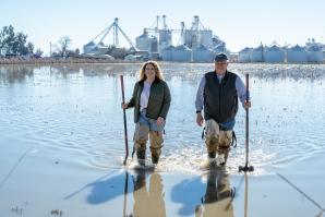 Brita Lundberg, left, and her father Bryce wade through the flooded fields at their nearly 90-year-old rice farm. (Photos courtesy of Lundberg Farms)