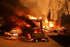 A wildfire engulfs cars and homes in Los Angeles in January 2025. (Shutterstock photo)