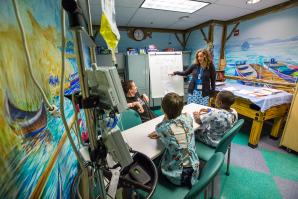 UC Davis Children’s Hospital teacher Nicole Castle warms up Richard, Reese and Jahmarcus with math puzzles before hitting the books. Castles is the sole instructor for all school-aged children in the pediatrics ward, as well as school-age patients in other wings of the hospital. In a given week she’ll schedule bedside sessions with as many as 30 students.